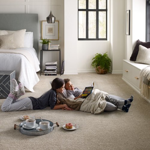 Kids are reading on beige soft carpet from Howard Carpenter Floor Covering in Danville KY