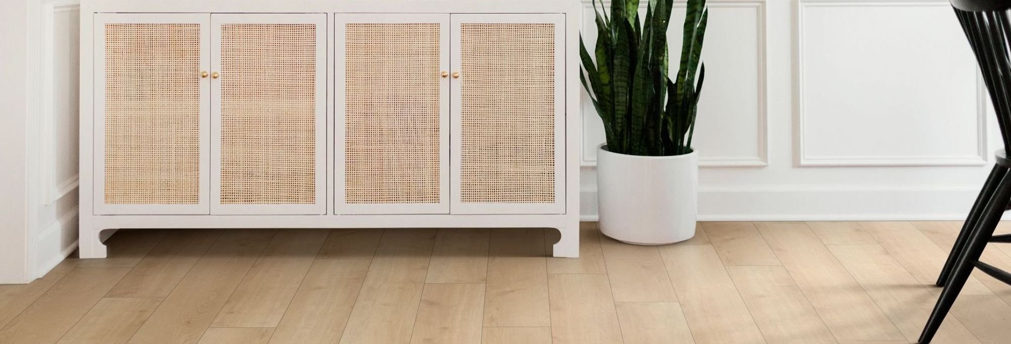 White cabinet next to a cactus on a brown laminate floor from Howard Carpenter Floor Covering in Danville KY