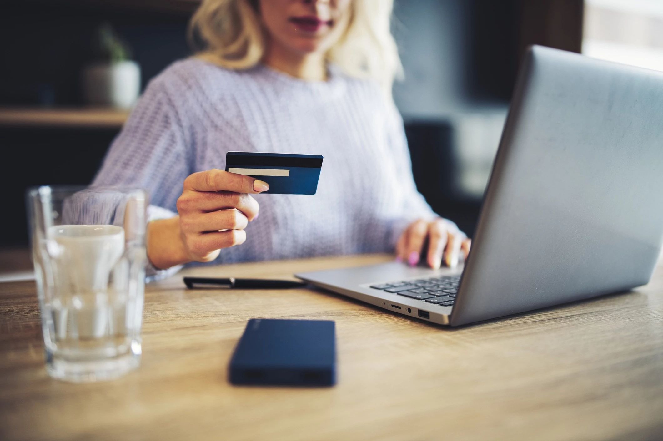 A woman uses her credit card to buy online flooring products from Howard Carpenter Floor Covering in Danville KY