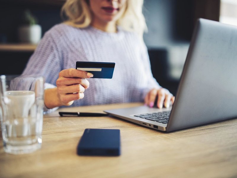 A woman uses her credit card to buy online flooring products from Howard Carpenter Floor Covering in Danville KY