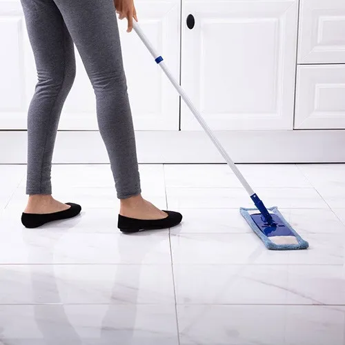 Lady cleaning tile | Howard-Carpenter Floor Covering