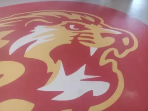 lion logo on floor | Howard-Carpenter Floor Covering