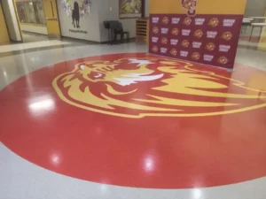 lion logo on floor | Howard-Carpenter Floor Covering