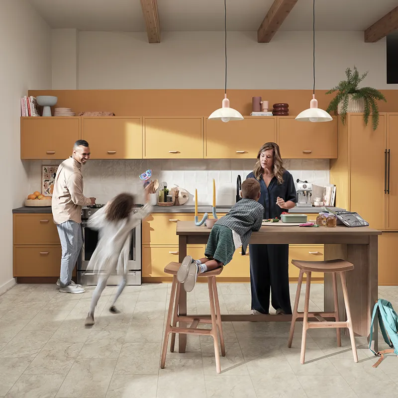 Modern kitchen with vinyl flooring. An active family is preparing lunch while dancing | Howard-Carpenter Floor Covering