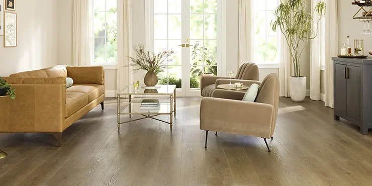 Contemporary living room with warm luxury vinyl flooring | Howard-Carpenter Floor Covering